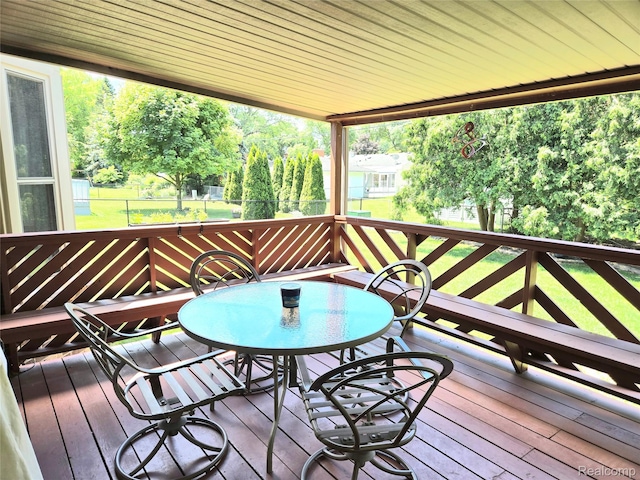 14879 Riverside St, Livonia, MI 48154 - wooden deck featuring outdoor dining space and view of scattered trees