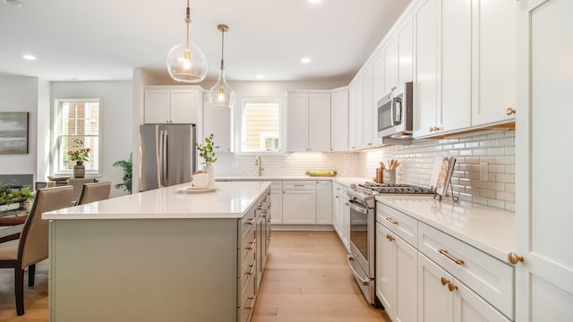 kitchen featuring light wood-style flooring, a healthy amount of sunlight, recessed lighting, and stainless steel appliances