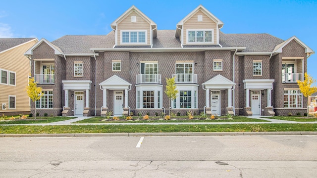townhome / multi-family property with brick siding