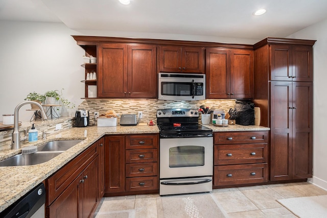 kitchen featuring open shelves, a sink, stainless steel appliances, decorative backsplash, and light stone counters