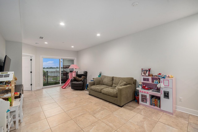 living area featuring light tile patterned floors, baseboards, recessed lighting, and visible vents