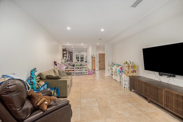 living room featuring light tile patterned floors, visible vents, and recessed lighting