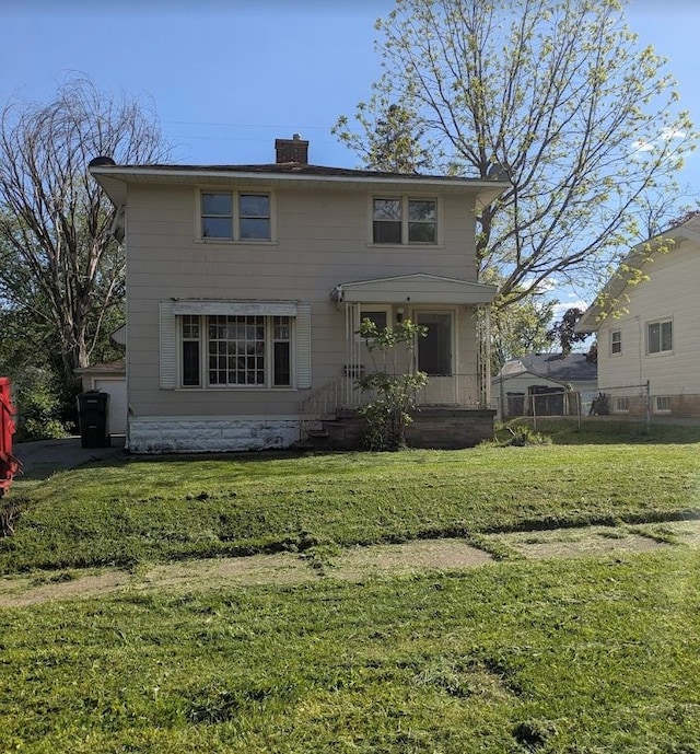 2557 Tiffin St, Flint, MI 48504 - view of front of home with a chimney, a front lawn, and covered porch