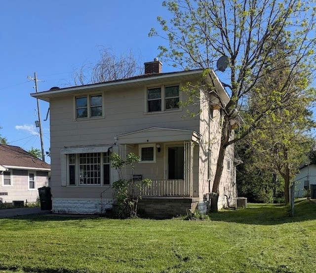 2557 Tiffin St, Flint, MI 48504 - rear view of house with a yard, a chimney, and central AC