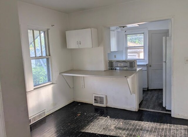 2557 Tiffin St, Flint, MI 48504 - kitchen featuring freestanding refrigerator, plenty of natural light, white cabinetry, and stainless steel microwave