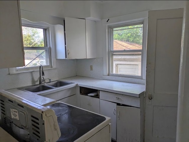 2557 Tiffin St, Flint, MI 48504 - kitchen featuring a sink, white cabinetry, and light countertops