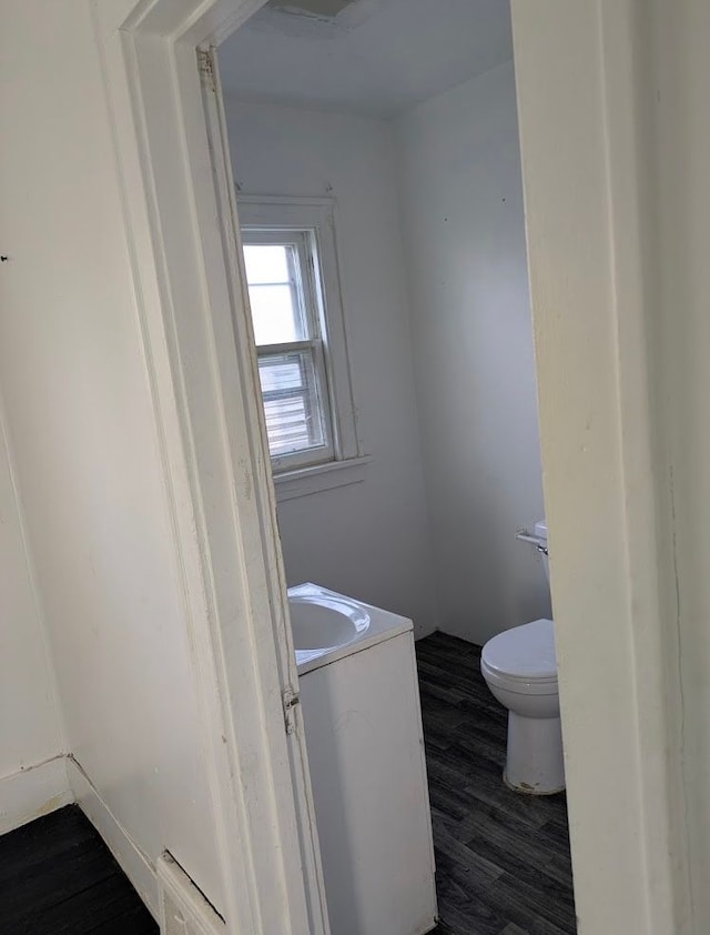 2557 Tiffin St, Flint, MI 48504 - bathroom featuring wood finished floors, toilet, and vanity