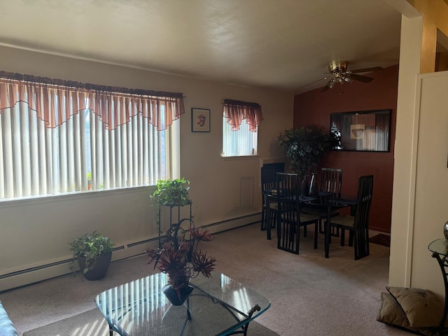 carpeted living area with a baseboard heating unit and a ceiling fan