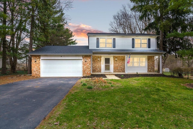 3715 W Hiawatha Dr, Okemos, MI 48864 - traditional-style home with a garage, brick siding, driveway, and a front lawn