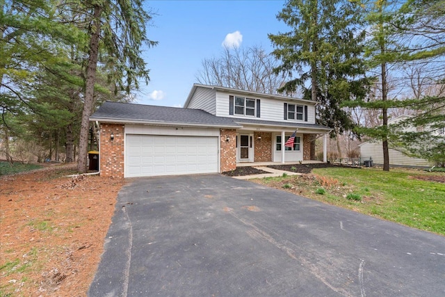 3715 W Hiawatha Dr, Okemos, MI 48864 - traditional-style home featuring an attached garage, a porch, driveway, and brick siding