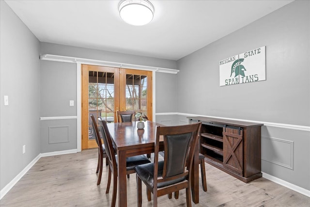 3715 W Hiawatha Dr, Okemos, MI 48864 - dining space with french doors, baseboards, and light wood-style floors