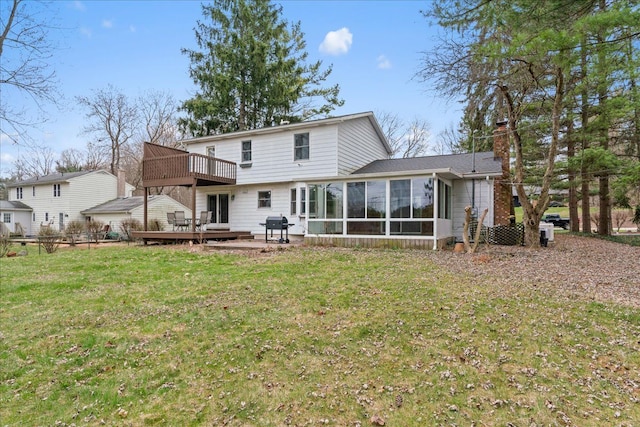 3715 W Hiawatha Dr, Okemos, MI 48864 - back of house with a wooden deck, a chimney, a sunroom, and a lawn