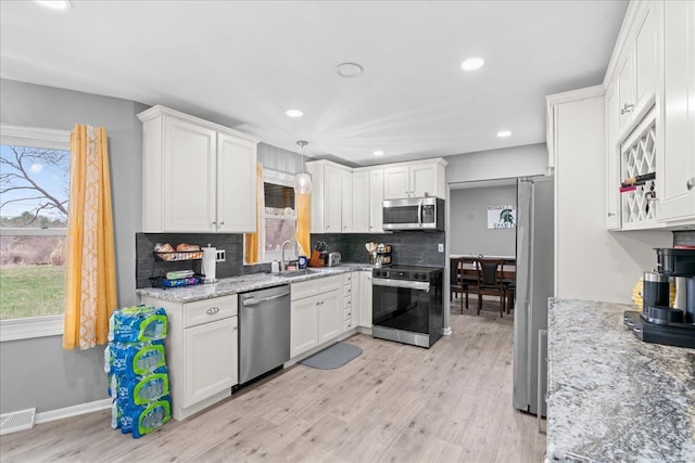 3715 W Hiawatha Dr, Okemos, MI 48864 - kitchen with plenty of natural light, visible vents, a sink, and appliances with stainless steel finishes