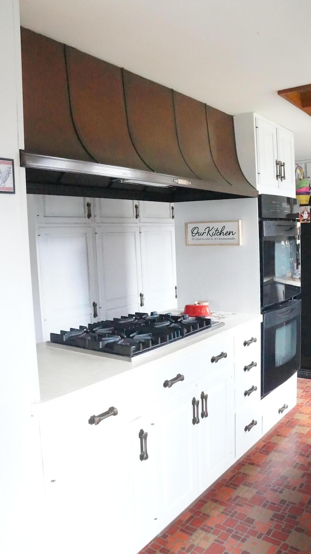 11340 Mccrone Rd, Milan, MI 48160 - kitchen with gas stovetop, brick floors, white cabinetry, and light countertops