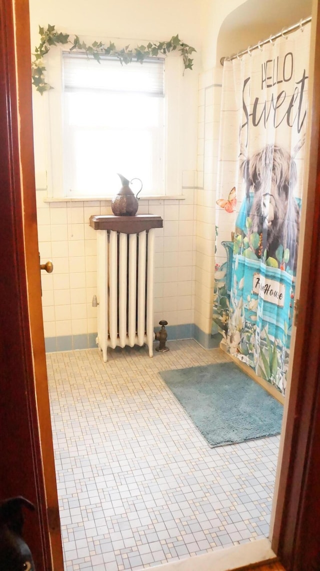 11340 Mccrone Rd, Milan, MI 48160 - hallway with radiator heating unit, tile walls, and tile patterned floors