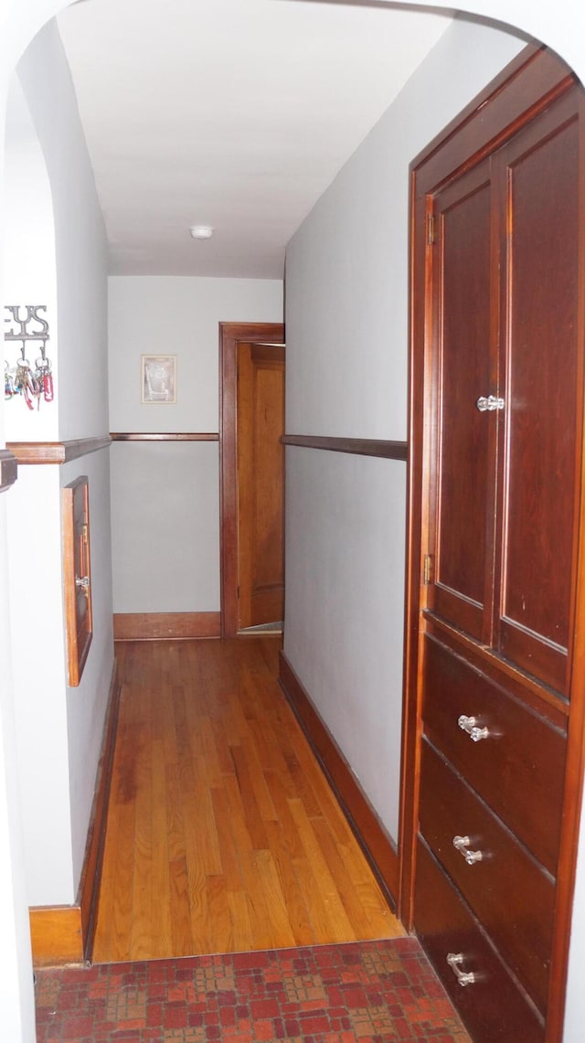 11340 Mccrone Rd, Milan, MI 48160 - hall with arched walkways, baseboards, and light wood finished floors