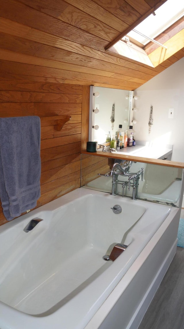 11340 Mccrone Rd, Milan, MI 48160 - full bath featuring a skylight, a bath, and wood finished floors