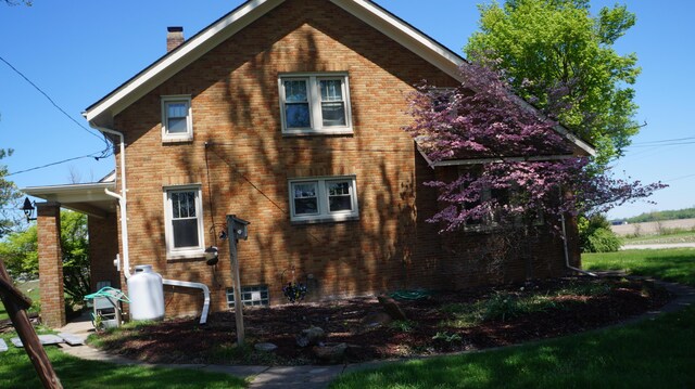 11340 Mccrone Rd, Milan, MI 48160 - view of property exterior with brick siding and a chimney