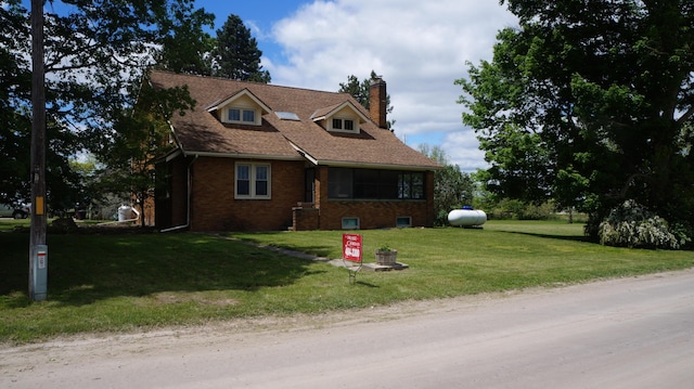 11340 Mccrone Rd, Milan, MI 48160 - view of front of home with a chimney, brick siding, and a front yard