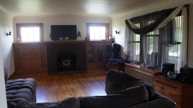 11340 Mccrone Rd, Milan, MI 48160 - living area with a fireplace, wood finished floors, and plenty of natural light