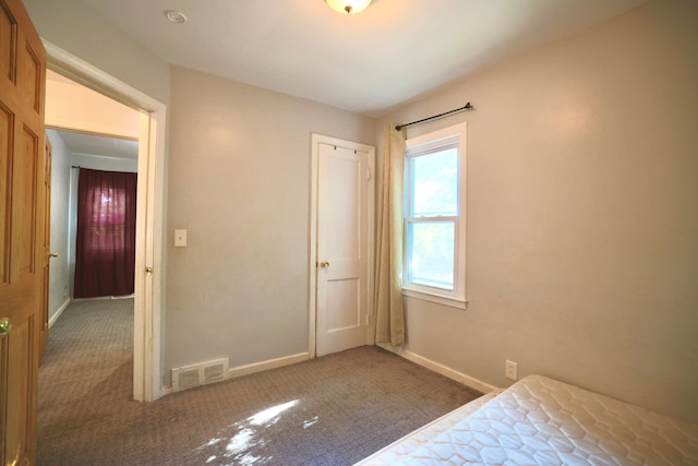 3638 Katherine St, Dearborn, MI 48124 - unfurnished bedroom featuring visible vents, baseboards, a closet, and carpet floors