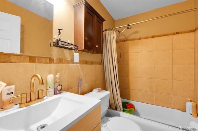 bathroom with shower / bathtub combination with curtain, toilet, vanity, and tile walls