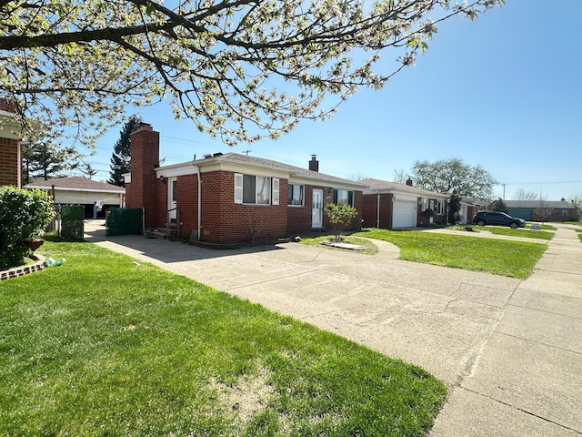 ranch-style home with a chimney, brick siding, a garage, a front lawn, and concrete driveway