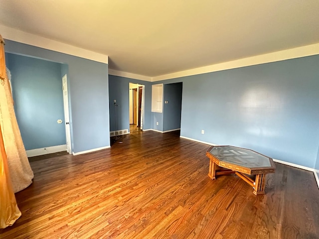 unfurnished room with wood finished floors and baseboards