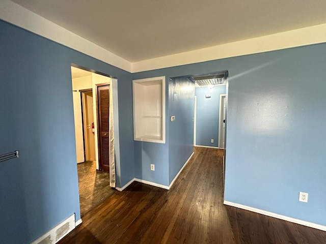 hall with wood finished floors and baseboards