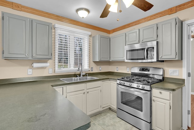 2515 N Lake Pleasant Rd, Attica, MI 48412 - kitchen featuring appliances with stainless steel finishes, a sink, dark countertops, gray cabinetry, and ceiling fan