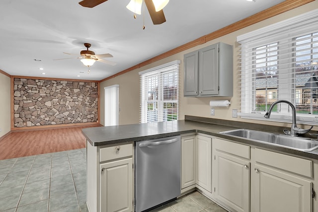 2515 N Lake Pleasant Rd, Attica, MI 48412 - kitchen with stainless steel dishwasher, a sink, a ceiling fan, a peninsula, and dark countertops