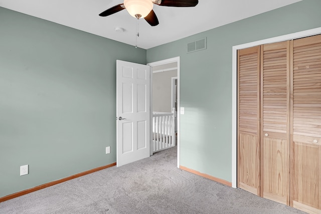 2515 N Lake Pleasant Rd, Attica, MI 48412 - unfurnished bedroom with carpet, baseboards, a closet, and ceiling fan