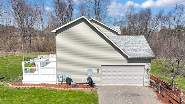 2515 N Lake Pleasant Rd, Attica, MI 48412 - view of property exterior with asphalt driveway, roof with shingles, a lawn, a garage, and cooling unit