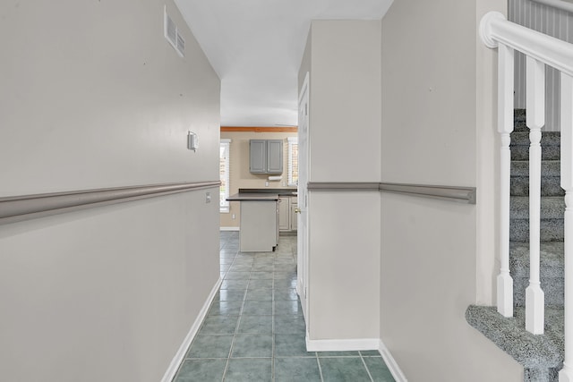 2515 N Lake Pleasant Rd, Attica, MI 48412 - hall featuring baseboards, stairs, and light tile patterned flooring