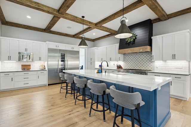 kitchen with beam ceiling, stainless steel built in fridge, coffered ceiling, and decorative backsplash