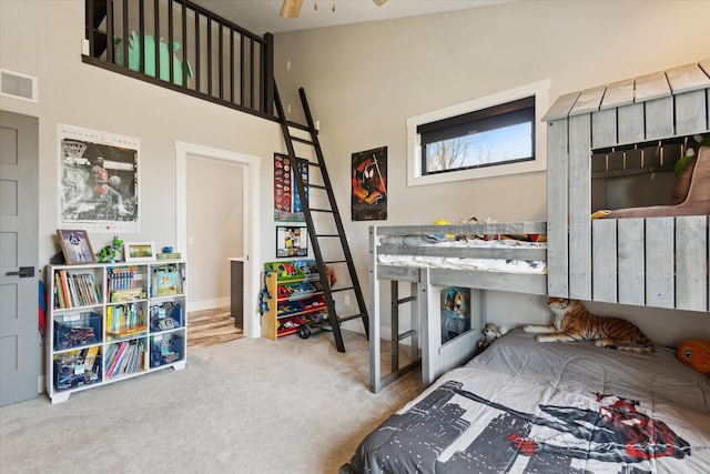 bedroom with visible vents and carpet
