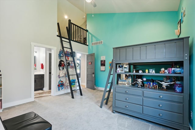 bedroom with baseboards, high vaulted ceiling, visible vents, and carpet
