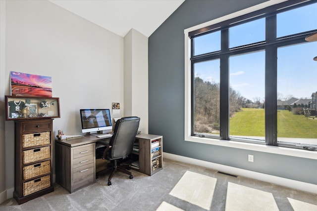office area with baseboards, visible vents, light carpet, and lofted ceiling