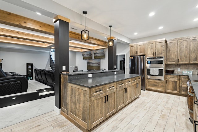 kitchen featuring dark stone countertops, pendant lighting, stainless steel appliances, light wood-type flooring, and recessed lighting