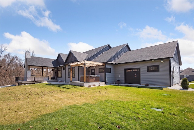 back of property with a pergola, a yard, an attached garage, and a hot tub