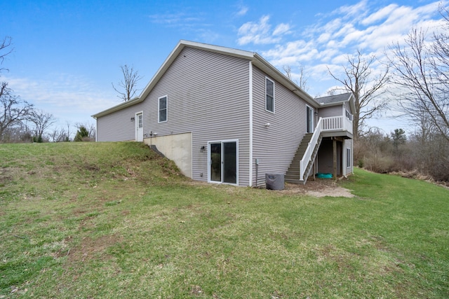 view of side of home with a yard and stairway