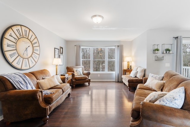 living area featuring baseboards and dark wood finished floors