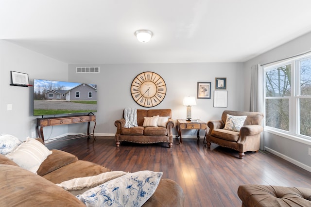 living room featuring baseboards, wood-type flooring, and visible vents