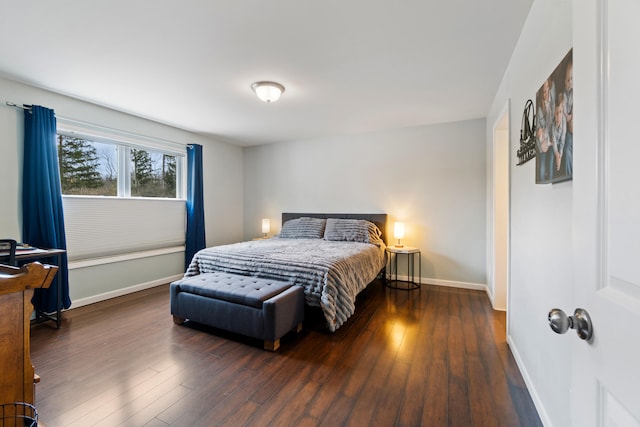 bedroom featuring wood finished floors and baseboards
