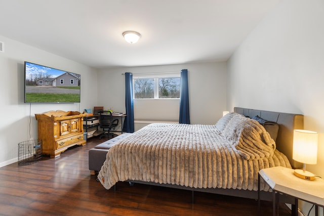 bedroom featuring visible vents and wood finished floors