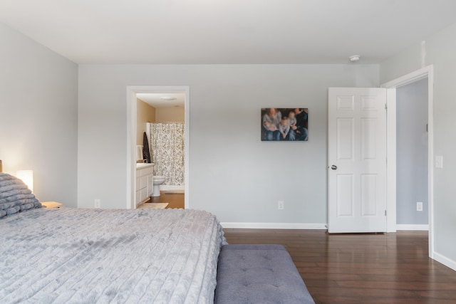 bedroom with wood finished floors and baseboards