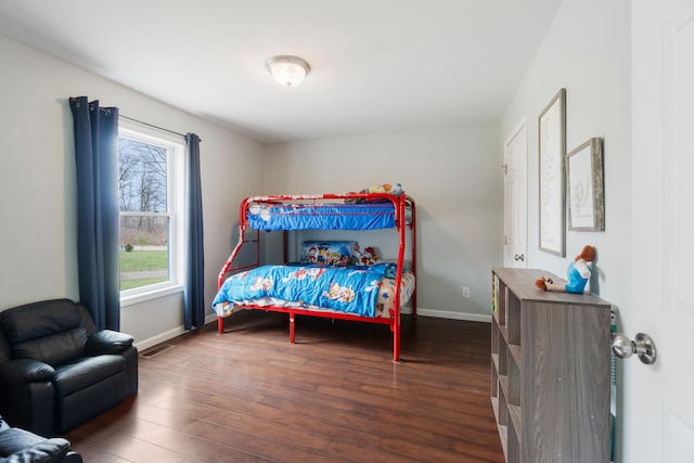 bedroom with dark wood-style flooring, baseboards, and visible vents
