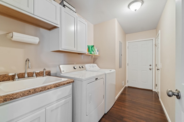 laundry room featuring baseboards, washer and dryer, a sink, dark wood finished floors, and cabinet space