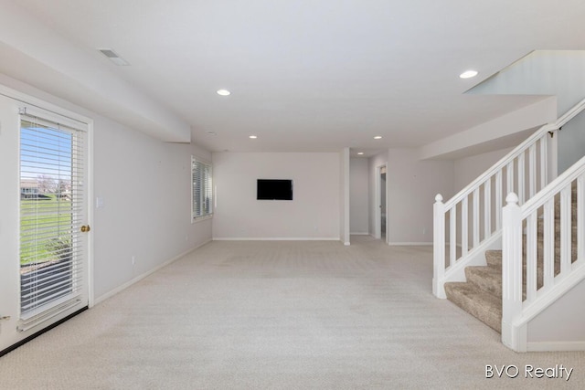 unfurnished living room featuring carpet floors, recessed lighting, visible vents, and stairs