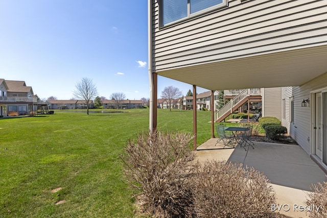 view of yard with a patio area, a residential view, and stairway